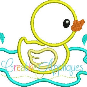 May include: A yellow rubber ducky with a blue beak and orange feet is swimming in a blue puddle with water splashes.