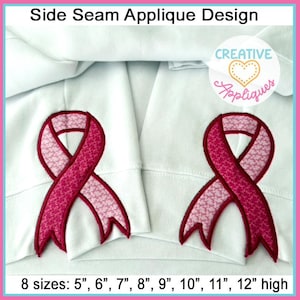 May include: Two pink ribbon applique designs on white fabric. The ribbons are pink with a white pattern and are available in eight sizes: 5", 6", 7", 8", 9", 10", 11", and 12" high.