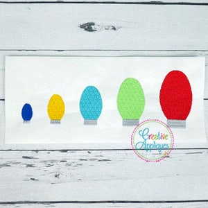 May include: Five Christmas lights in different sizes and colors. The lights are red, green, blue, yellow, and light blue. The lights are arranged in a row from largest to smallest.