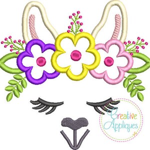 May include: Embroidered design of a llama face with closed eyes and a gray nose. The llama is wearing a flower crown with purple, yellow, and pink flowers.