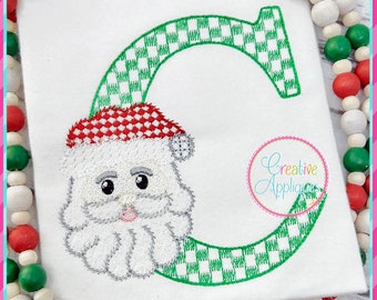 May include: Embroidered design of the letter C with a Santa Claus face and a green and white checkered background. The design is available in four sizes: 4 inches, 5 inches, 6 inches, and 7 inches.