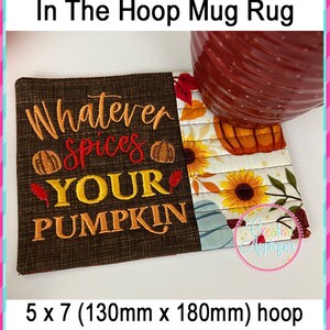 May include: Embroidered mug rug with a brown background and the text "Whatever Spices Your Pumpkin". The rug is decorated with fall-themed designs, including pumpkins, sunflowers, and leaves. It is designed for a 5x7 inch (130mm x 180mm) hoop.