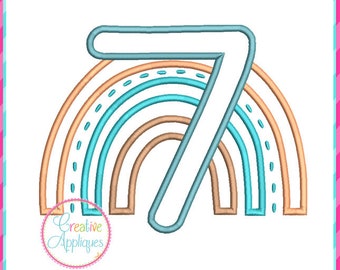 May include: Embroidered design of the number 7 with a rainbow behind it. The rainbow is made up of three arches in shades of orange, blue, and brown.