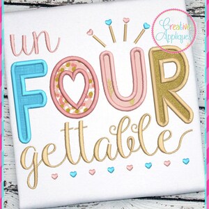 May include: White fabric with the words "un FOUR gettable" embroidered in various colors. The word "FOUR" has a heart in the center. The design includes hearts and starbursts, with the text "Creative Appliques" in a circle.
