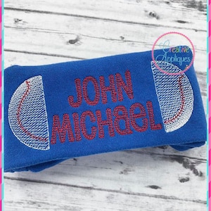 May include: Blue fabric with a red and white baseball design and the names "JOHN MICHAEL" embroidered in red.