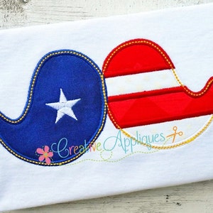 May include: A pair of felt appliques in the shape of mustaches. One mustache is red, white, and blue with a striped pattern. The other mustache is blue with a white star in the center. Both mustaches have a yellow outline.