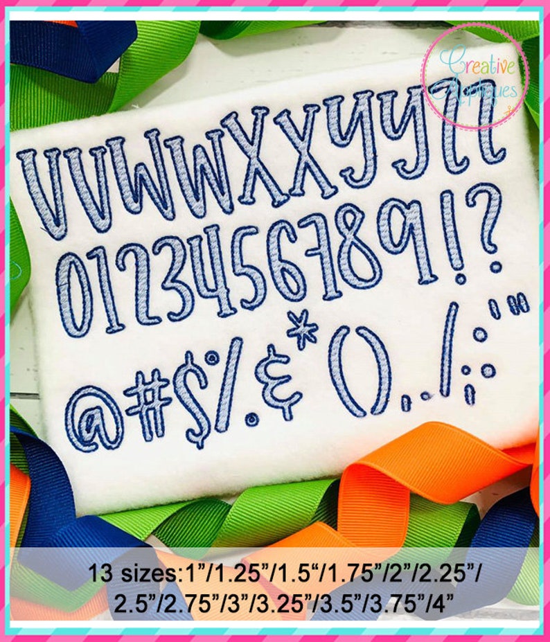 May include: A white fabric with blue embroidered letters, numbers, and symbols. The letters are uppercase and include V, W, X, Y, Z. The numbers are 0 through 9. The symbols include @, #, $, %, &, *, (, ), ., /, :, and !. The text "13 sizes: 1"/1.25"/1.5"/1.75"/2"/2.25"/ 2.5"/2.75"/3"/3.25"/3.5"/3.75"/4" is printed below the embroidered letters, numbers, and symbols.