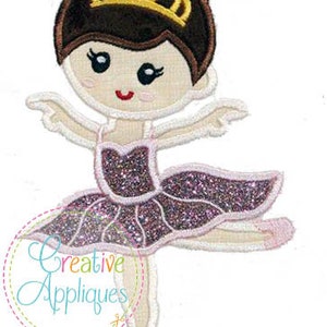May include: Embroidered design of a ballerina with brown hair, a gold crown, and a pink and purple tutu. The ballerina is in a dancing pose with one leg raised.