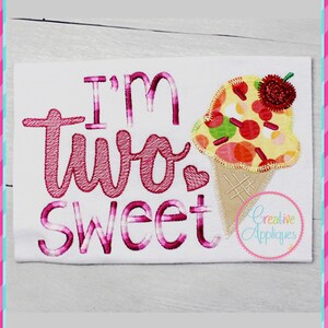 May include: Embroidered design on a white fabric with the text "I'm two sweet" in pink and a pink and yellow ice cream cone with a red cherry on top.