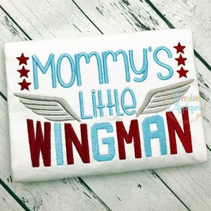 May include: White embroidered baby onesie with the text "Mommy's Little Wingman" in red, blue, and gray with two stars on each side of the text.