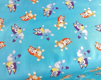 Bluey and Bingo cotton fabric, by half yard, soft orange, yellow, black white, light blue background, colorful fabric, light blue background