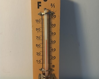 Vintage wooden-backed Fahrenheit thermometer with a red liquid column.