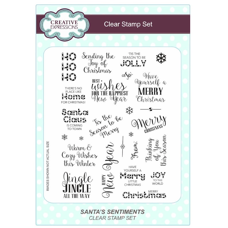 May include: A clear stamp set with a variety of Christmas greetings, including "Ho Ho Ho", "Sending the Joy of Christmas", "Tis the Season to be Jolly", "Best Wishes for the Happiest New Year", "Have Yourself a Merry Christmas", "Santa Claus is Coming to Town", "Warm & Cozy Wishes this Winter", "Jingle Jingle All the Way", "Merry Christmas", "Happy New Year", "From: Thinking of You this Season", "Have Yourself a Merry Little Christmas", "Joy to the World", "Merry Christmas". The stamp set is packaged in a clear plastic sleeve with a white background and a pink border.