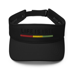 May include: Black visor with the text "LIFE IS IRIE" embroidered in white with a red, yellow, and green stripe underneath.