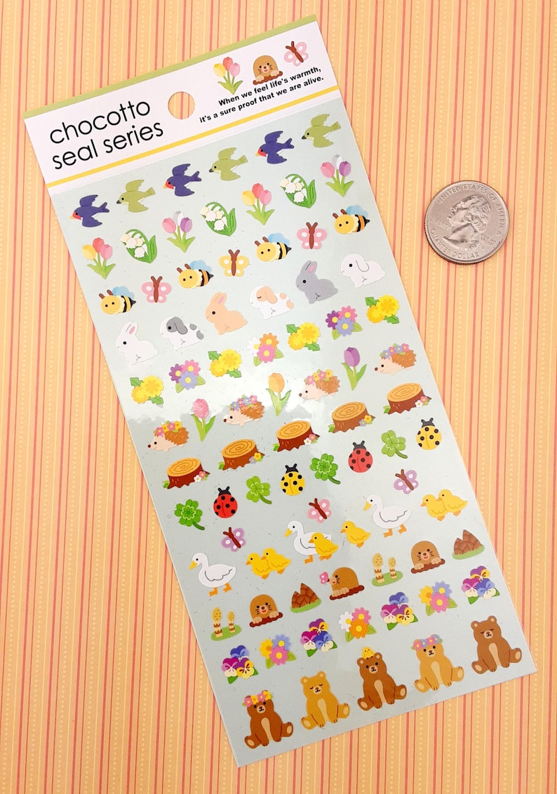 May include: A sheet of colorful stickers featuring various spring-themed designs, including flowers, butterflies, bees, rabbits, hedgehogs, ducks, and bears. The stickers are on a light blue background with the text "chocotto seal series" at the top.