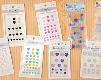 May include: Assortment of decorative stickers featuring hearts and stars in various colours and designs. The stickers are packaged in clear plastic bags and sheets.