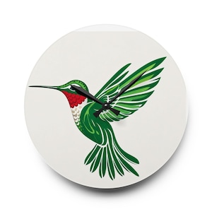 May include: A round wall clock featuring a graphic illustration of a hummingbird in flight. The bird has vibrant green wings and body, a bright red throat patch, and a white chest. Three black clock hands are centered over the bird's body.
