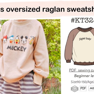 May include: A beige raglan sweatshirt with a Mickey Mouse print and the text "MICKEY". The sweatshirt is oversized and has a brown and beige color scheme. The image also shows a line drawing of a similar sweatshirt with the text "Super baby" on the front.