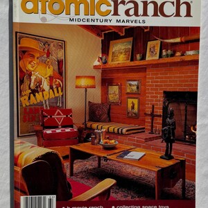 May include: The cover of "atomic ranch" magazine, winter 2006 issue, features a midcentury modern interior. The cover includes a living room with a fireplace, artwork, and a coffee table. The magazine's cover also includes the text "MIDCENTURY MARVELS".