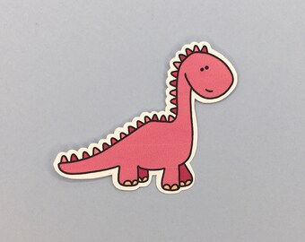 May include: A pink cartoon dinosaur with red spikes on its back. The dinosaur has a smiling face with two black eyes.