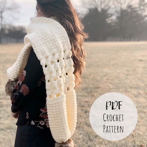 May include: A white crochet scarf with a lacy pattern. The scarf is worn by a person standing in a field. The text "PDF CROCHET PATTERN" is on a white circle.