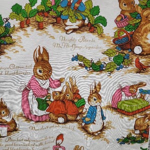 May include: A white fabric with a repeating pattern of brown rabbits, green plants, and red carrots. The text "Naughty Peter in Mr. McGregor's garden" is printed on the fabric.