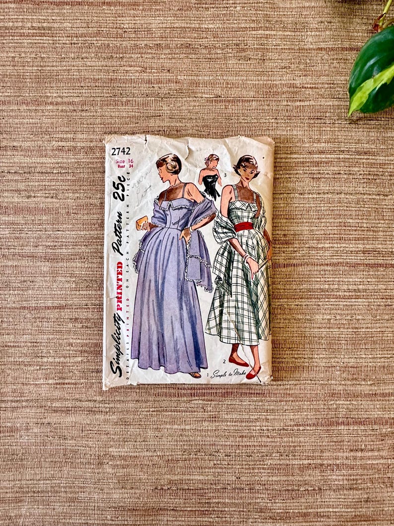 May include: Vintage Simplicity printed sewing pattern 2742. The pattern features illustrations of women's dresses, including a long, light purple gown and a plaid dress with a red belt. The pattern is marked "25c" and "Size 16".