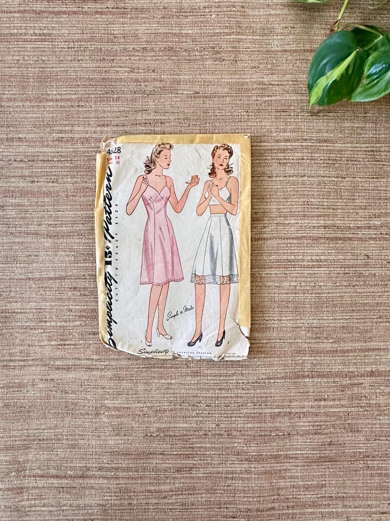 May include: Vintage Simplicity 15&cent; Pattern envelope featuring illustrations of two women in lingerie. One woman is in a pink slip dress, the other in a white bra and skirt. The envelope is yellowed with age.