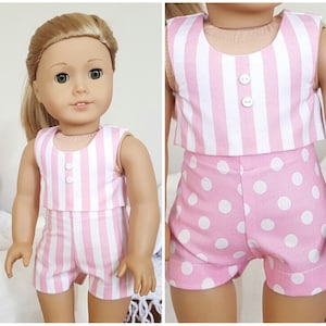 May include: A pink and white striped sleeveless top with white buttons and matching pink and white polka dot shorts. The outfit is designed for a doll.