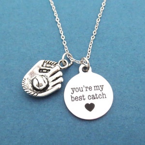 May include: Silver necklace with a baseball glove charm and a round pendant that says "you're my best catch" with a small heart.