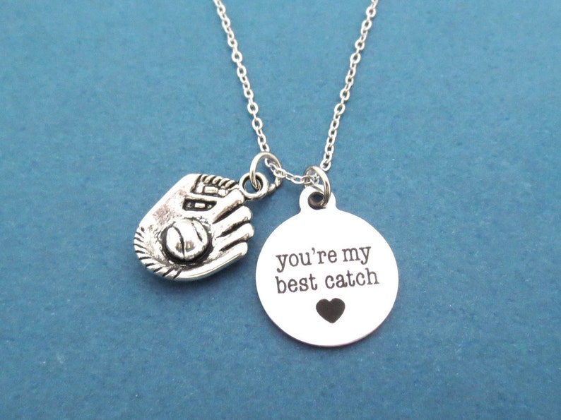 May include: Silver necklace with a baseball glove charm and a round pendant that says "you're my best catch" with a small heart.