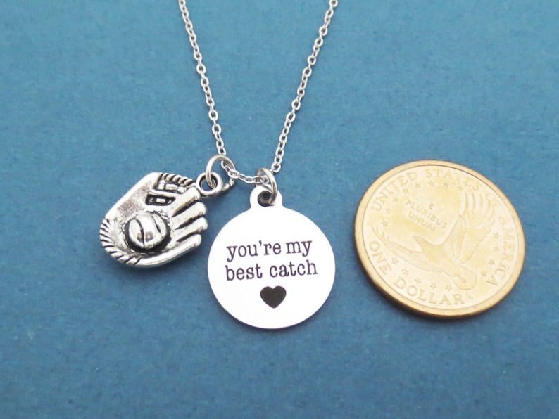 May include: Silver necklace with a baseball glove charm and a round pendant that says "you're my best catch" with a small heart cutout.