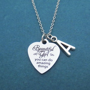 May include: Silver necklace with a heart-shaped pendant that says "Beautiful Girl you can do amazing things" and a charm with the letter A.