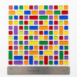 May include: A colorful mosaic tile design composed of various rectangular and square shapes in shades of red, orange, yellow, green, blue, and purple. A stainless steel ruler is placed below the mosaic, measuring approximately 6 inches.
