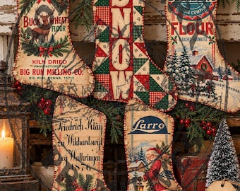 May include: Five decorative Christmas stockings featuring vintage-style graphics. Designs include Big Run Buckwheat Flour, a red and green patchwork SNOW pattern, Russell Miller Occident Flour, Friedrich Kläy 1876 text, and a Santa Claus illustration.