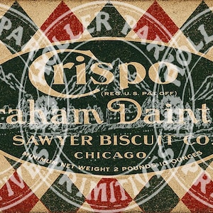 May include: A rectangular vintage-style label featuring a red, green, and beige diamond pattern. The central oval contains the text Crispo Graham Dainties, Sawyer Biscuit Co. Chicago, and the printed text Minimum Net Weight 2 Pounds 10 Ounces.