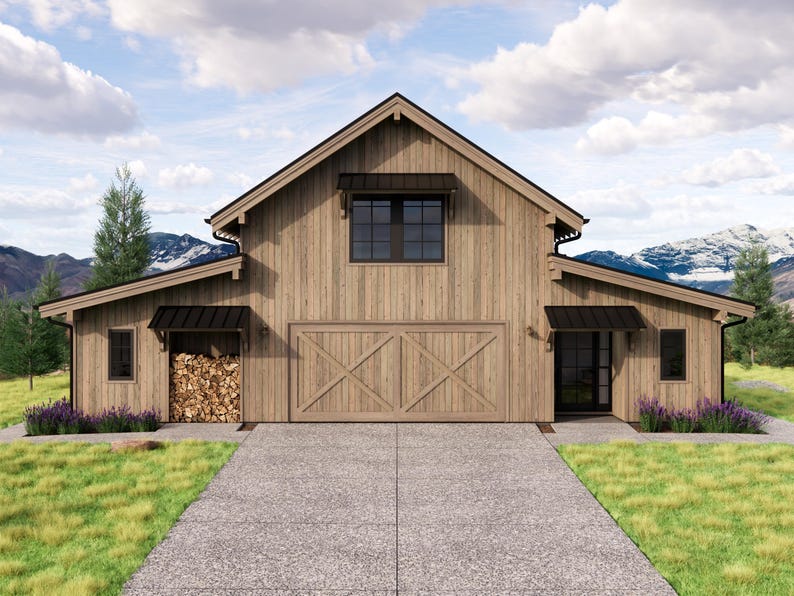 May include: A rustic wooden barn with a gabled roof, black window frames, and a large wooden door. The barn has a concrete driveway and is surrounded by green grass, trees, and mountains in the background.