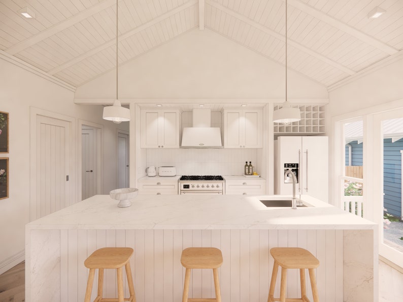 May include: A bright, modern kitchen with white cabinetry, countertops, and appliances. The kitchen island features three wooden stools. Overhead, two pendant lights hang above the island. The room has a vaulted ceiling and a window overlooking a backyard.