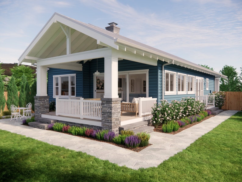 May include: A blue house with a white porch and trim. The house has a gabled roof and a stone foundation. A walkway leads to the front door, and there is a small table and chairs on the porch. Landscaping includes flowers and green grass.