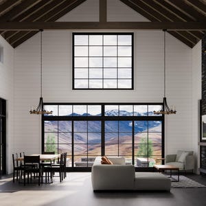 May include: Spacious, modern living room with large windows offering mountain views. Features include a sectional sofa, dining table, fireplace, and decorative chandeliers. The room has white walls, dark trim, and a high, wood-beamed ceiling.