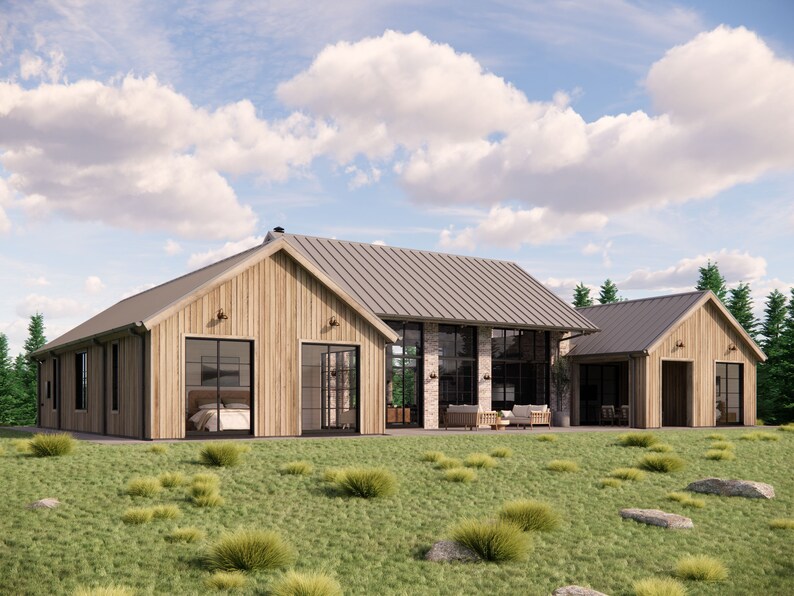 A rear angle view of Mill Farm, a home design by Turnervisual. Three pavilions made of a pleasant mix of rough sawn wood and recycled bricks intersect to form the structure of this luxurious farmhouse. The house is shown in a rural setting.