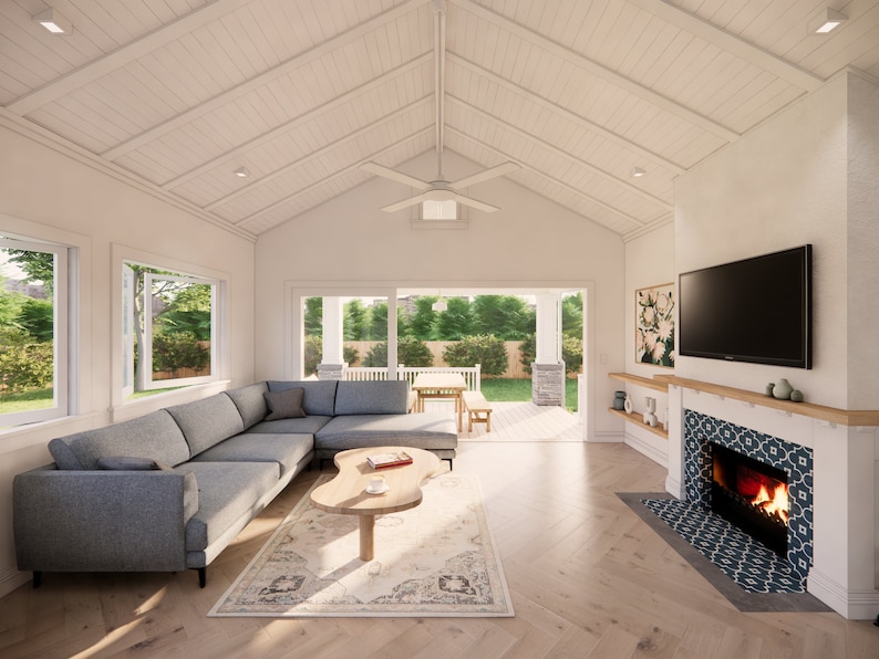 May include: A modern living room with a gray sectional sofa, a wooden coffee table, and a fireplace with a decorative tile surround. The room has large windows and a sliding glass door leading to an outdoor patio.
