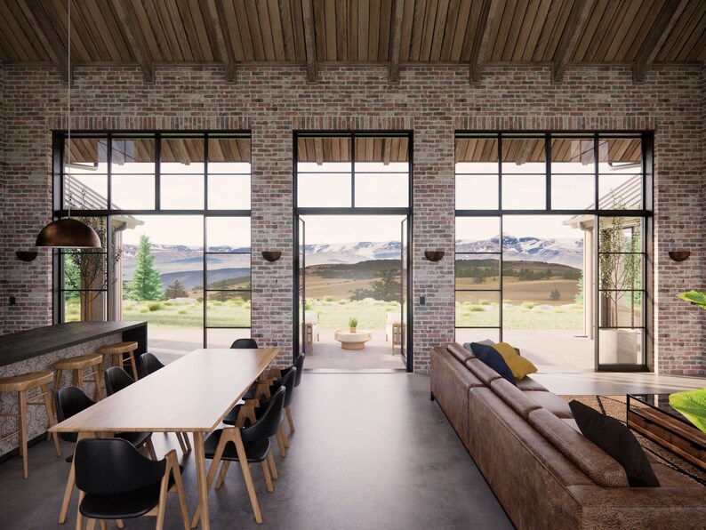 View from the entry area of Mill Farm, a house design by Turnervisual. There is an island bench, dining table and lounge that all share a view to mountains in the distance.