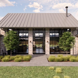 A rustic farmhouse made with reclaimed bricks in an alpine scene has large steel windows and doors on both sides. Snow capped mountains can be seen through the glazed living pavilion. The home features a metal roof with a chimney flue visible.