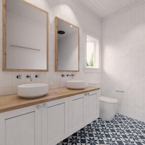 May include: A modern bathroom with white walls and a blue and white patterned tile floor. The room features two mirrors with wooden frames, two white sinks, and a white cabinet with a wooden countertop. A white toilet is also visible.