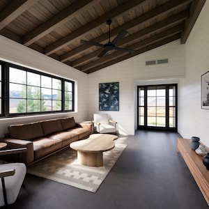 May include: A modern living room with a brown leather sofa, a wooden coffee table, and two white armchairs. The room features large windows with black frames, a black ceiling fan, and a wooden ceiling. Artwork and a rug complete the space.