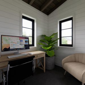 May include: A home office with a wooden desk, black chair, and a computer monitor displaying a colorful interface. A potted plant sits near a window, and a beige loveseat is in the corner. The walls are white with black window frames.