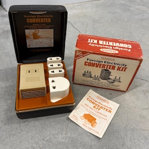 May include: A Franzus Foreign Electricity Converter Kit including a beige converter unit and three white plug adapters housed in a black case, a red cardboard box, and an instruction manual with 1600 watt capacity text.