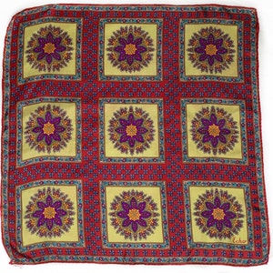 May include: A red silk scarf with a repeating pattern of yellow, purple, and orange floral designs. The scarf has a light yellow background and a dark blue border. The word "Echo" is printed in the bottom right corner.