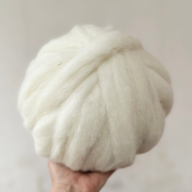 May include: A ball of white wool yarn, perfect for knitting or crocheting.